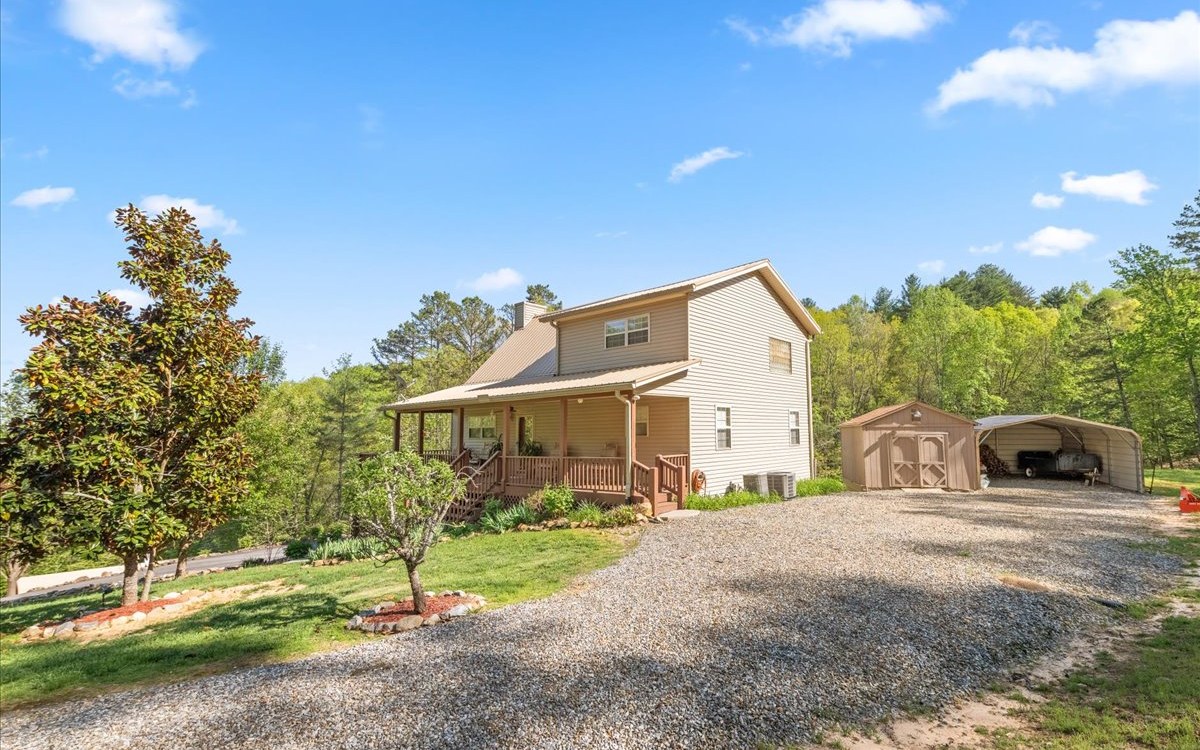 94 Mull Ln Circle Morganton, GA 30560 - Photo 62 of 67 a front view of a house with a yard and garage