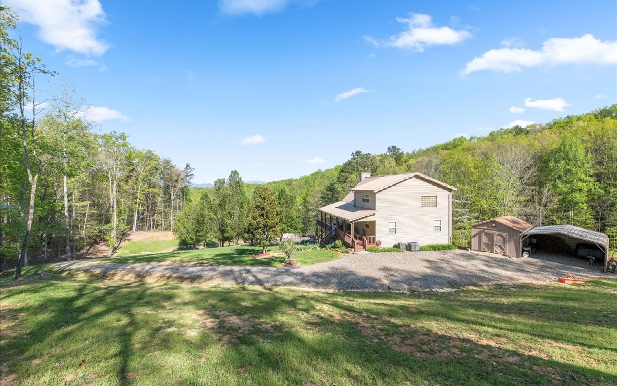 94 Mull Ln Circle Morganton, GA 30560 - Photo 63 of 67 a backyard of a house with table and chairs