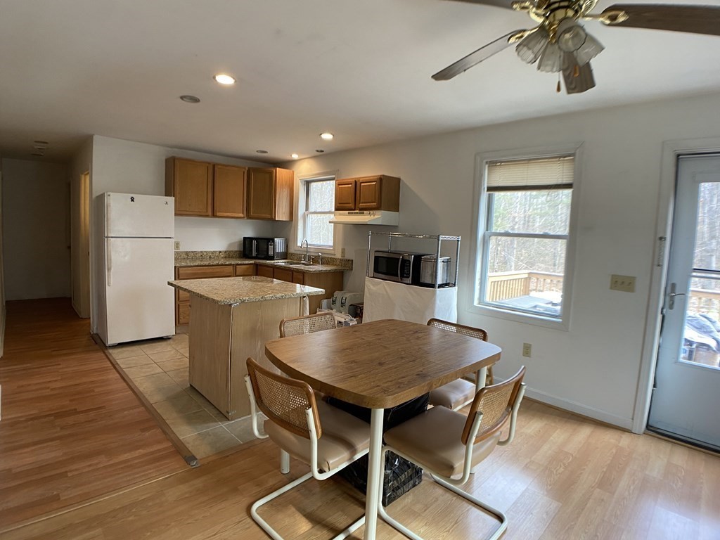 139 Union Road Wales, MA 01081 - Photo 4 of 15 a kitchen with stainless steel appliances a dining table chairs refrigerator and cabinets