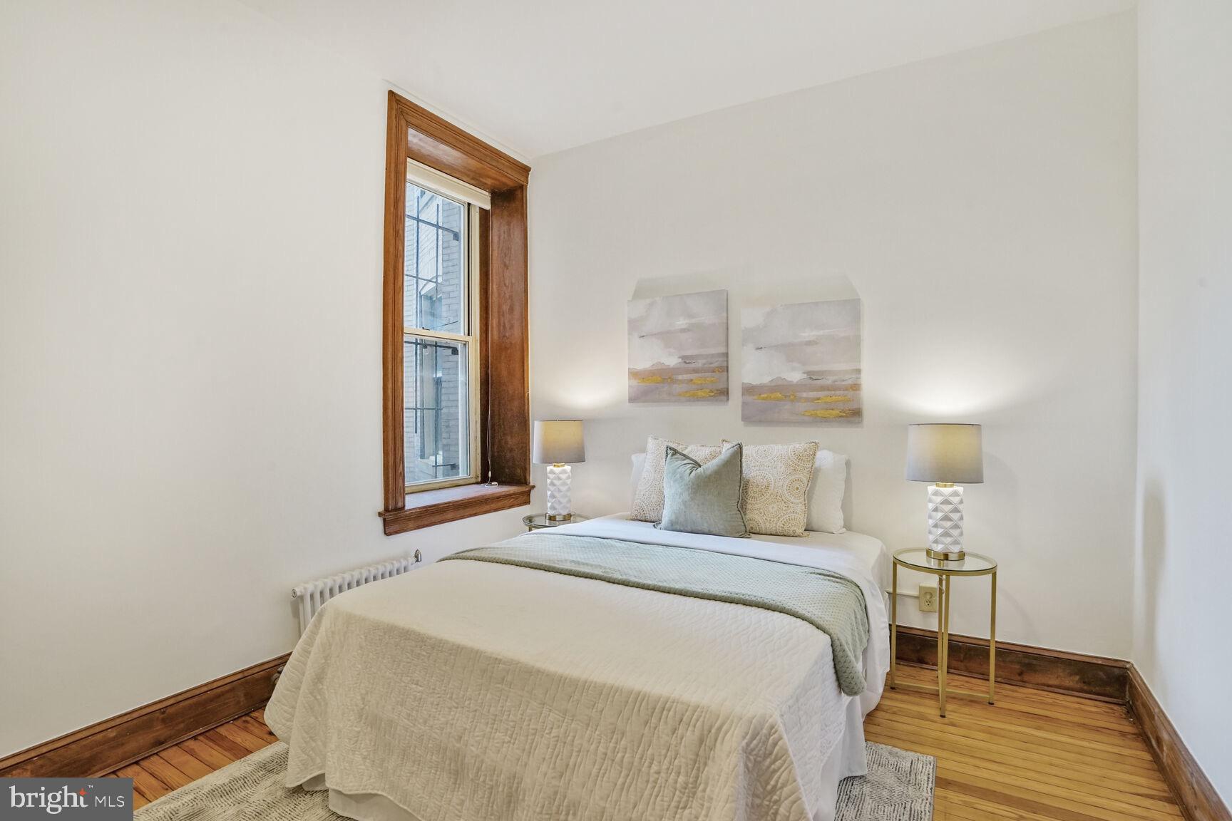 2022 Columbia Road Northwest, Unit 111 Washington, DC 20009 - Photo 24 of 43 a bedroom with a bed and a window