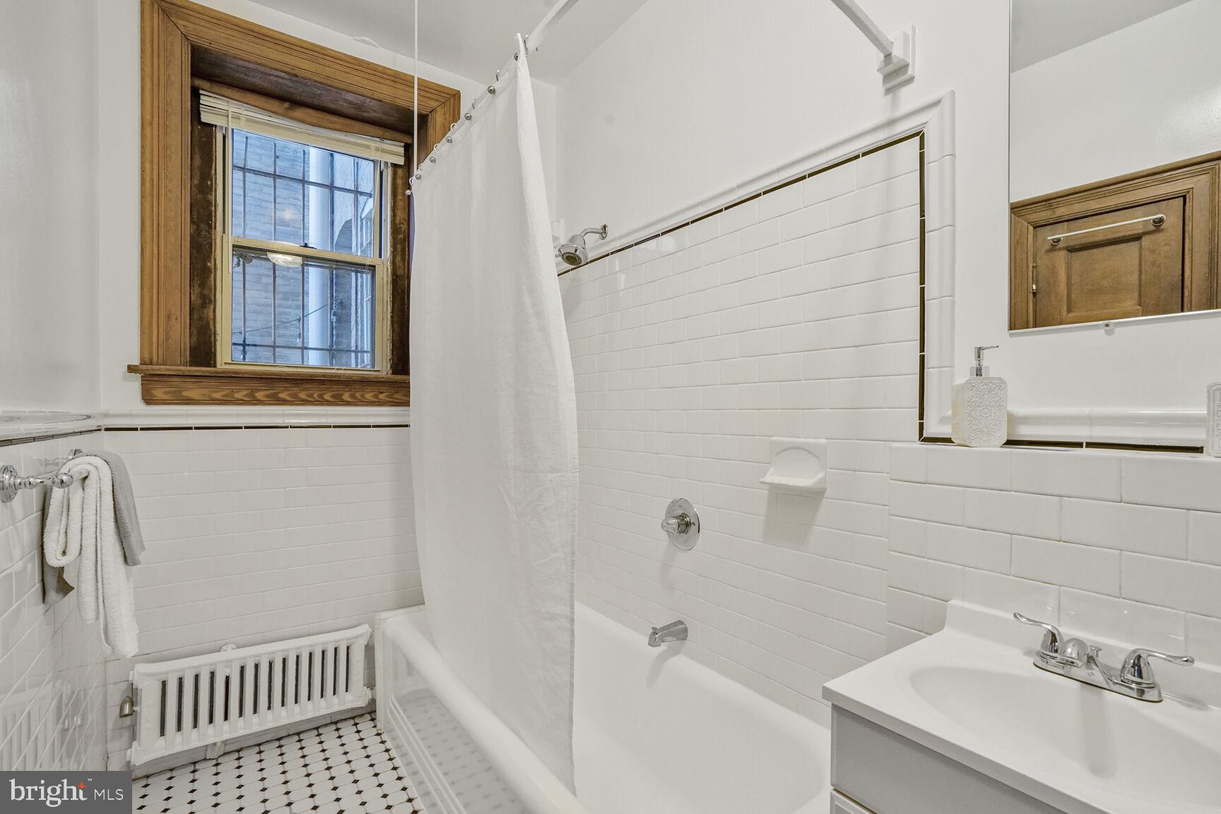 2022 Columbia Road Northwest, Unit 111 Washington, DC 20009 - Photo 27 of 43 a bathroom with a sink toilet and shower