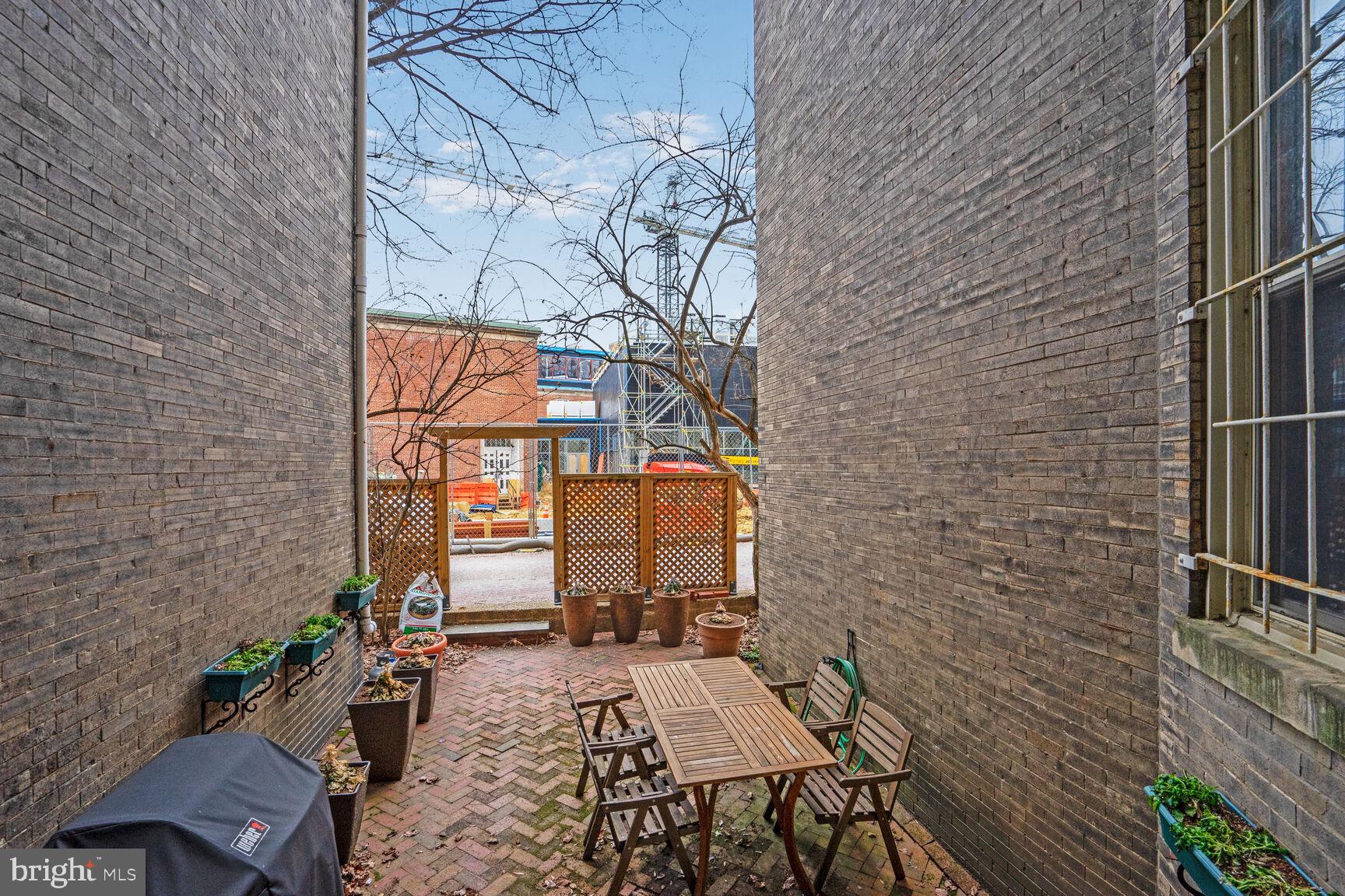 2022 Columbia Road Northwest, Unit 111 Washington, DC 20009 - Photo 30 of 43 a backyard of a house with seating space