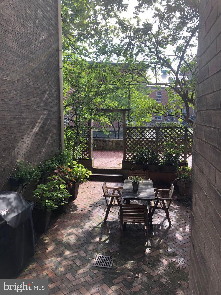2022 Columbia Road Northwest, Unit 111 Washington, DC 20009 - Photo 33 of 43 a bench sitting in middle of a yard