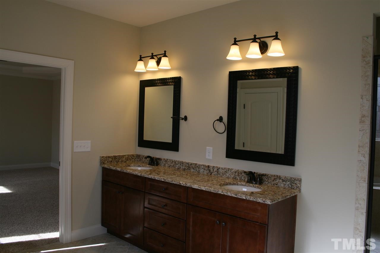 8605 Hurst Drive Raleigh, NC 27603 - Photo 11 of 17 a bathroom with mirror and sink view