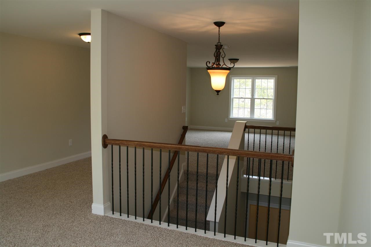 8605 Hurst Drive Raleigh, NC 27603 - Photo 16 of 17 a view of hallway with wooden floor