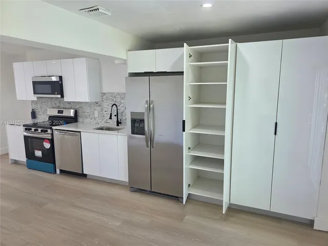 a utility room with cabinets