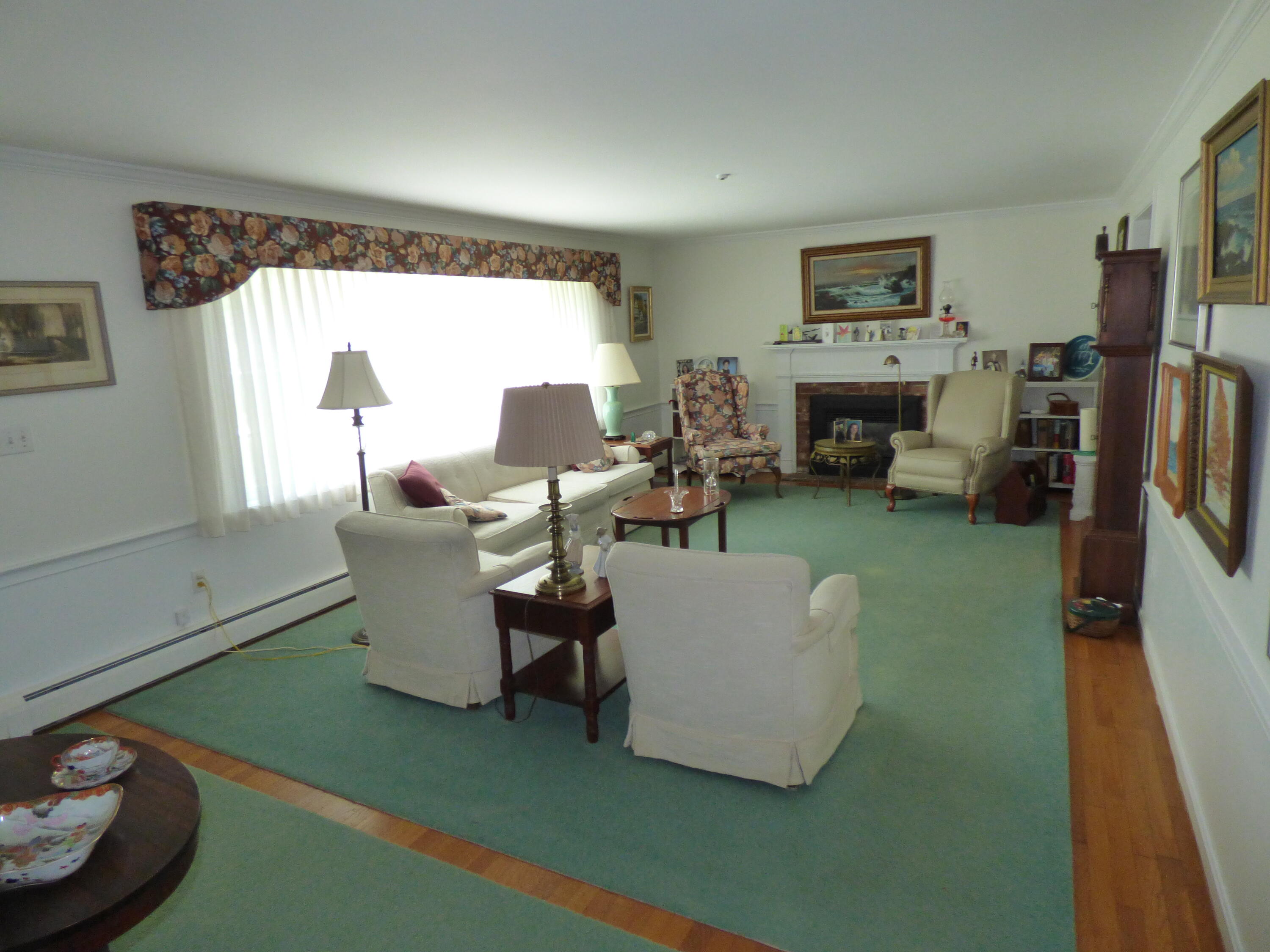 1415 Old Post Road Marstons Mills, MA 02648 - Photo 4 of 28 a living room with furniture a large window and a fireplace