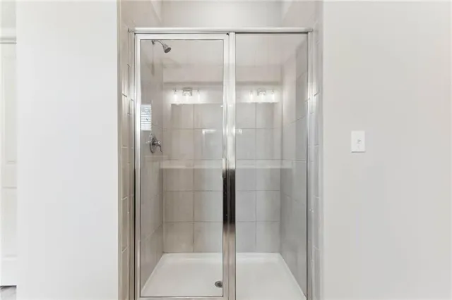 a bathroom with a glass shower door