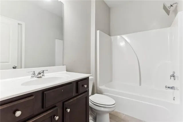 a bathroom with a sink a toilet and bathtub