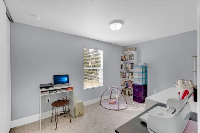 a room with furniture a flat screen tv and a window