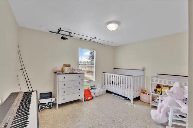 a view of a bedroom with baby crib