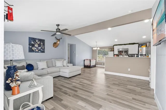 a living room with furniture and kitchen view