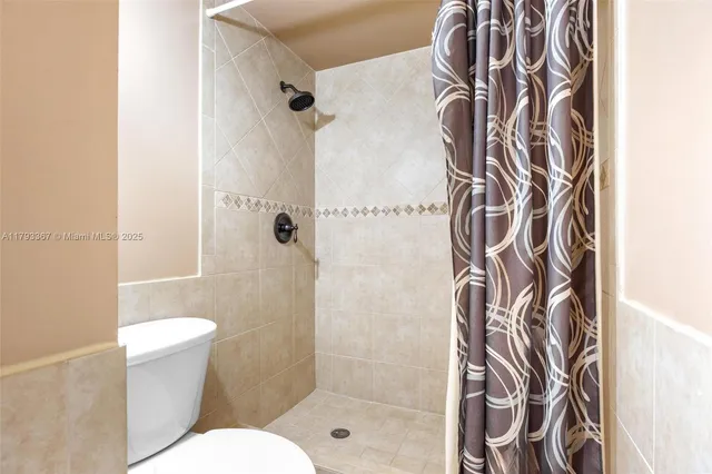 a bathroom with a shower and toilet