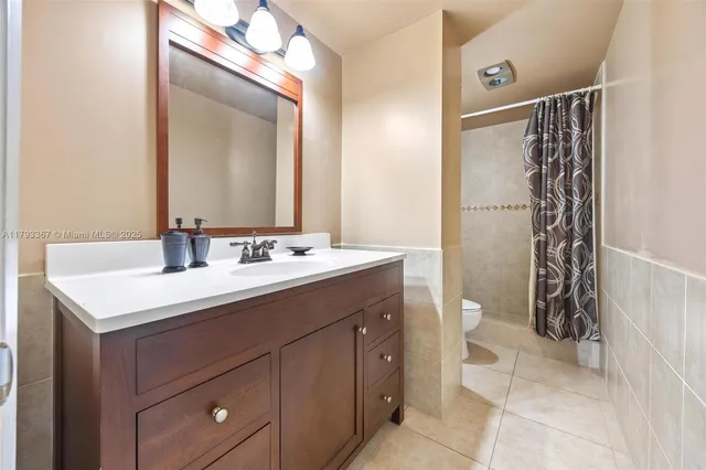 a bathroom with a sink vanity and a mirror