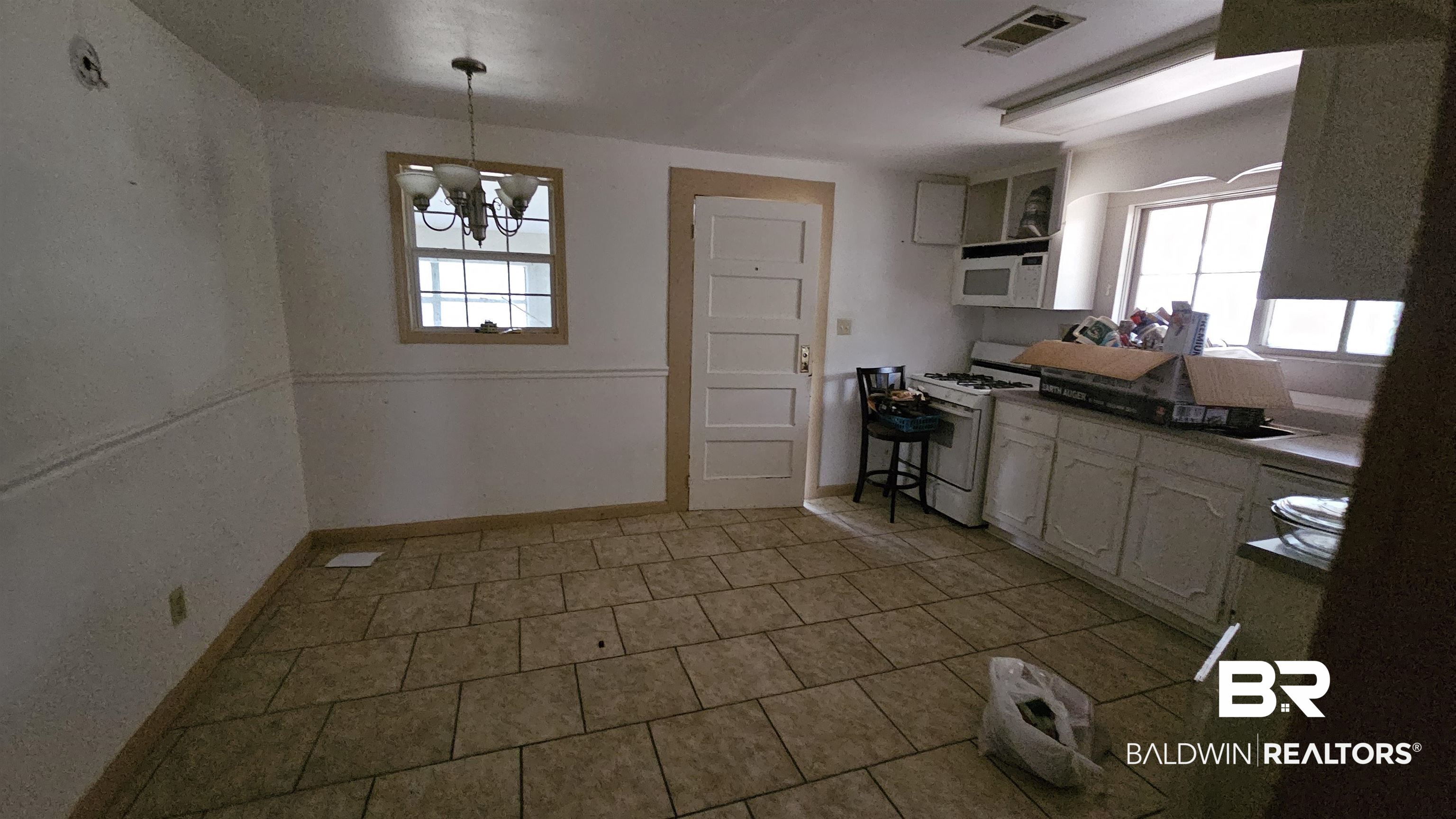 307 Scott Street Brewton, AL 36426 - Photo 9 of 19 Kitchen with white appliances, pendant lighting, and a notable chandelier