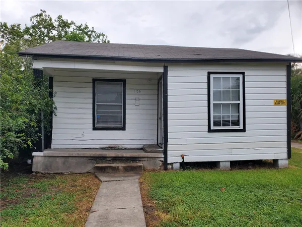 a side view of a house with a yard