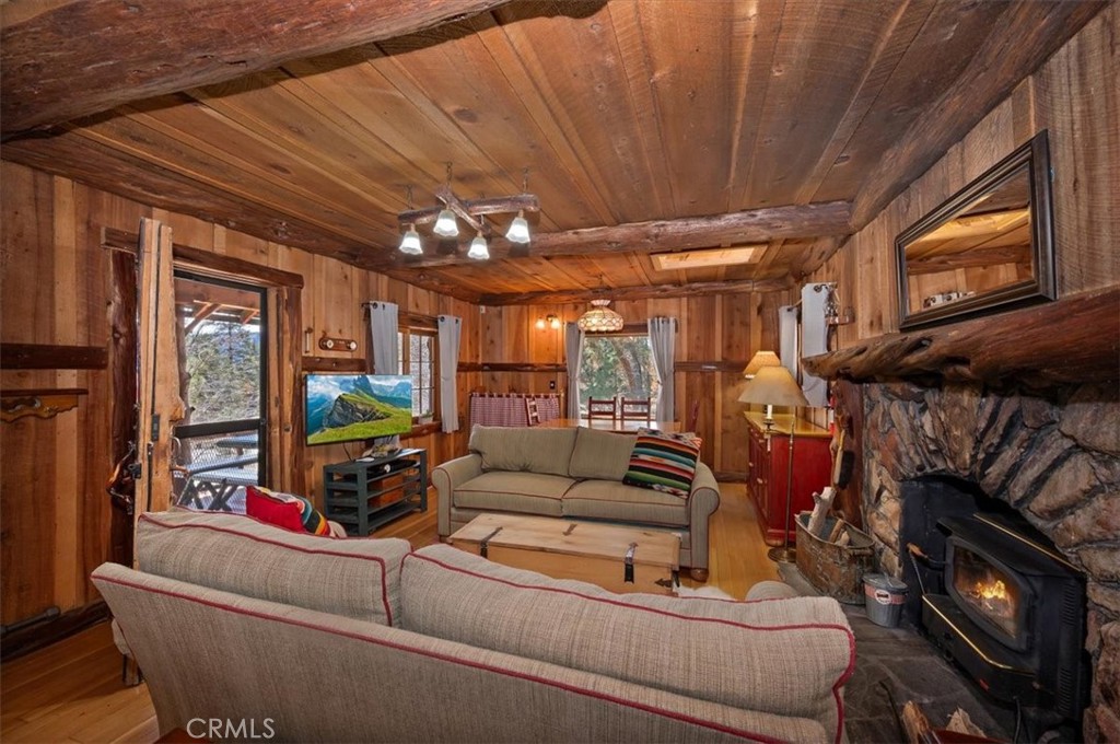 22 Polique Canyon Road Fawnskin, CA 92333 - Photo 6 of 42 Living Room boosts a wood Burning Stove in a stone fireplace