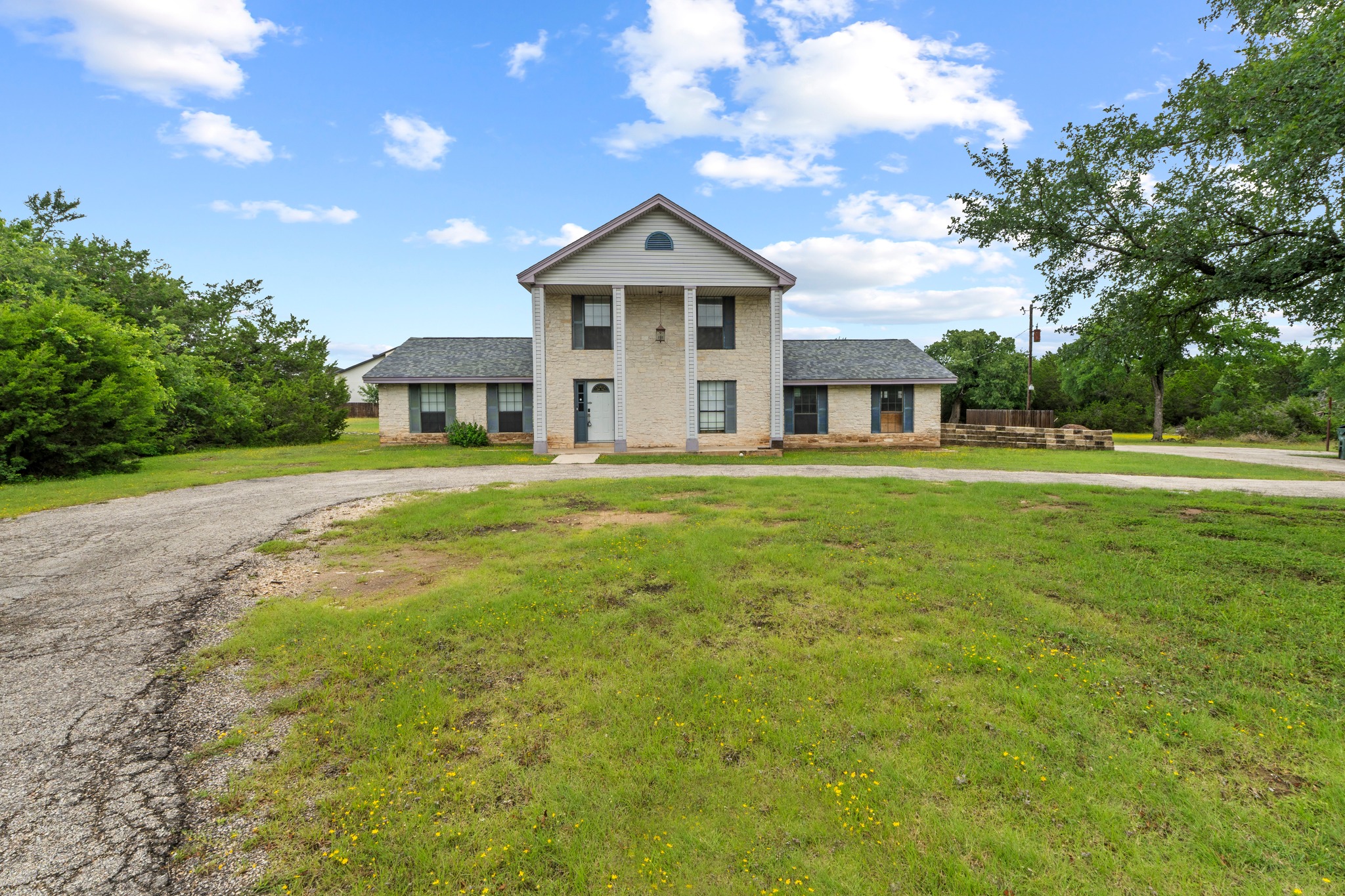 205 Sedro Trail Georgetown, TX 78633 - Photo 10 of 32 An inviting facade with grand columns welcomes you to this spacious property, surrounded by verdant foliage and mature trees.