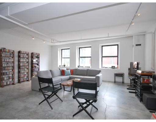 453 Washington Street, Unit 5A Boston, MA 02111 - Photo 1 of 1 a living room with furniture a dining table and a piano table
