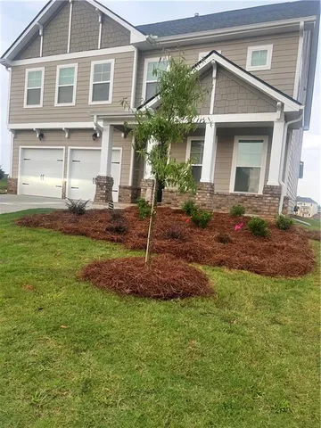 a front view of a house with a yard