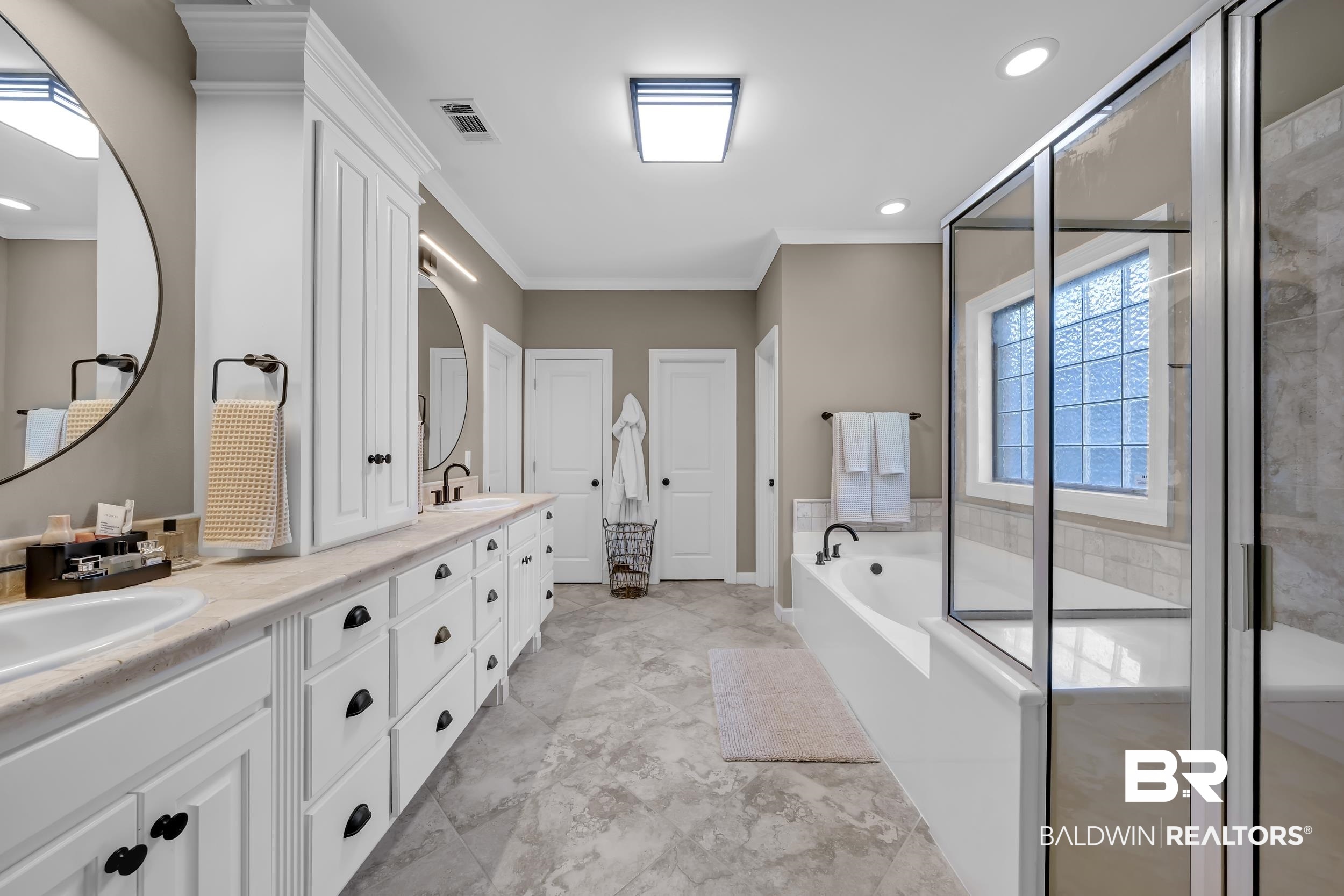 8137 Pine Run Daphne, AL 36527 - Photo 26 of 67 Dual vanity with undermount sinks, stone-look countertops, and white cabinetry