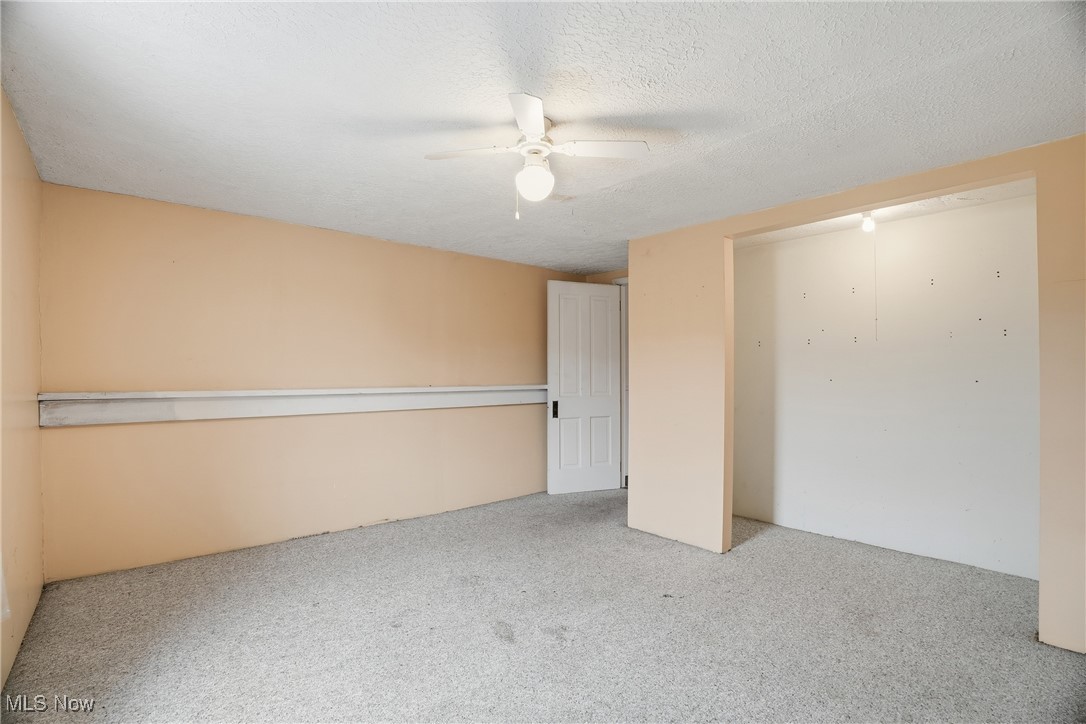 8045 Veto Road Belpre, OH 45714 - Photo 46 of 50 Unfurnished bedroom featuring carpet flooring, a textured ceiling, and a ceiling fan