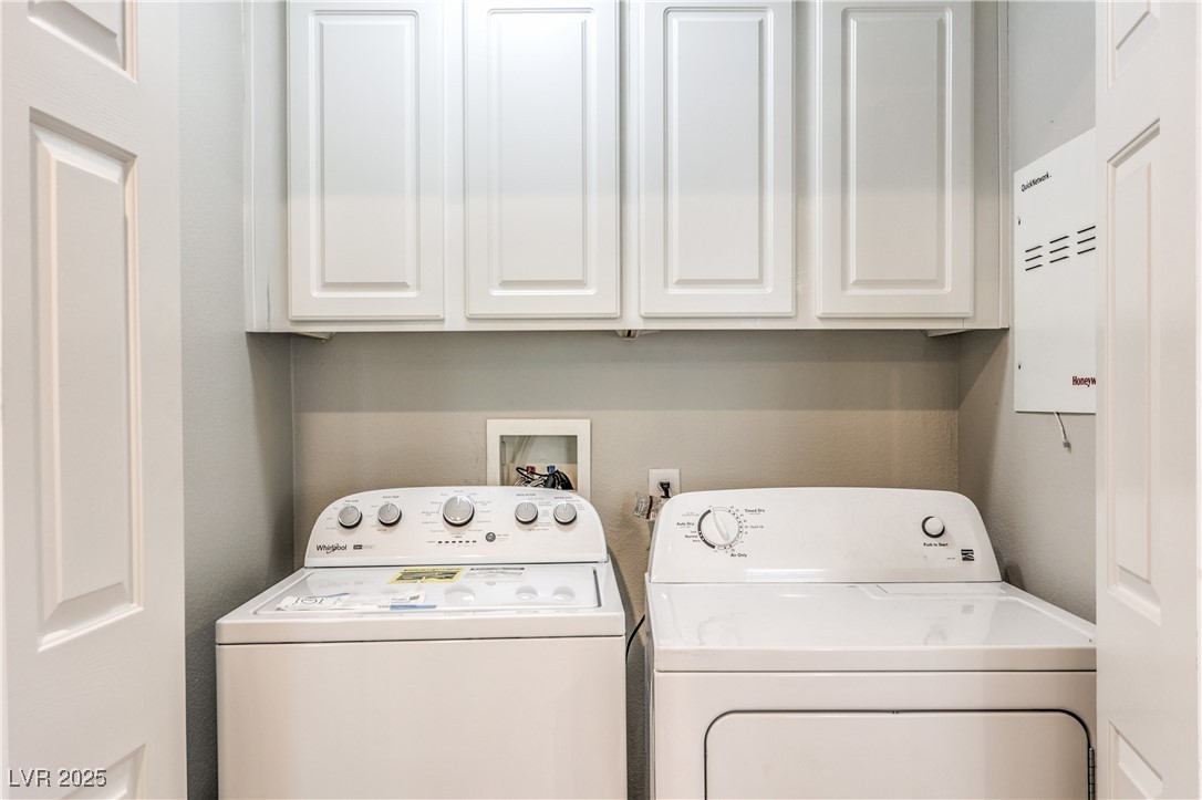 585 Foster Springs Road Las Vegas, NV 89148 - Photo 32 of 39 Laundry area featuring washing machine and dryer and cabinet space