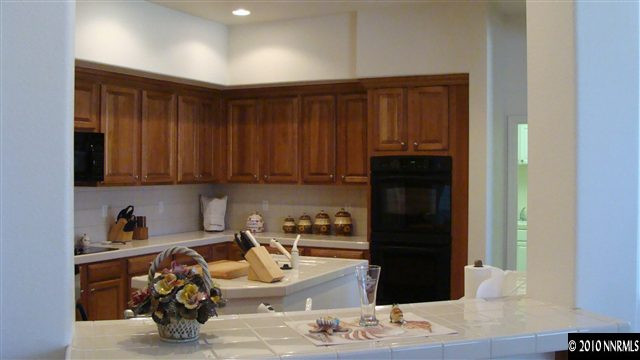 10545 Dillingham Drive Reno, NV 89521 - Photo 3 of 9 a kitchen with a refrigerator and cabinets