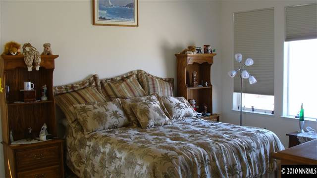 10545 Dillingham Drive Reno, NV 89521 - Photo 7 of 9 a bedroom with a bed and wooden floor