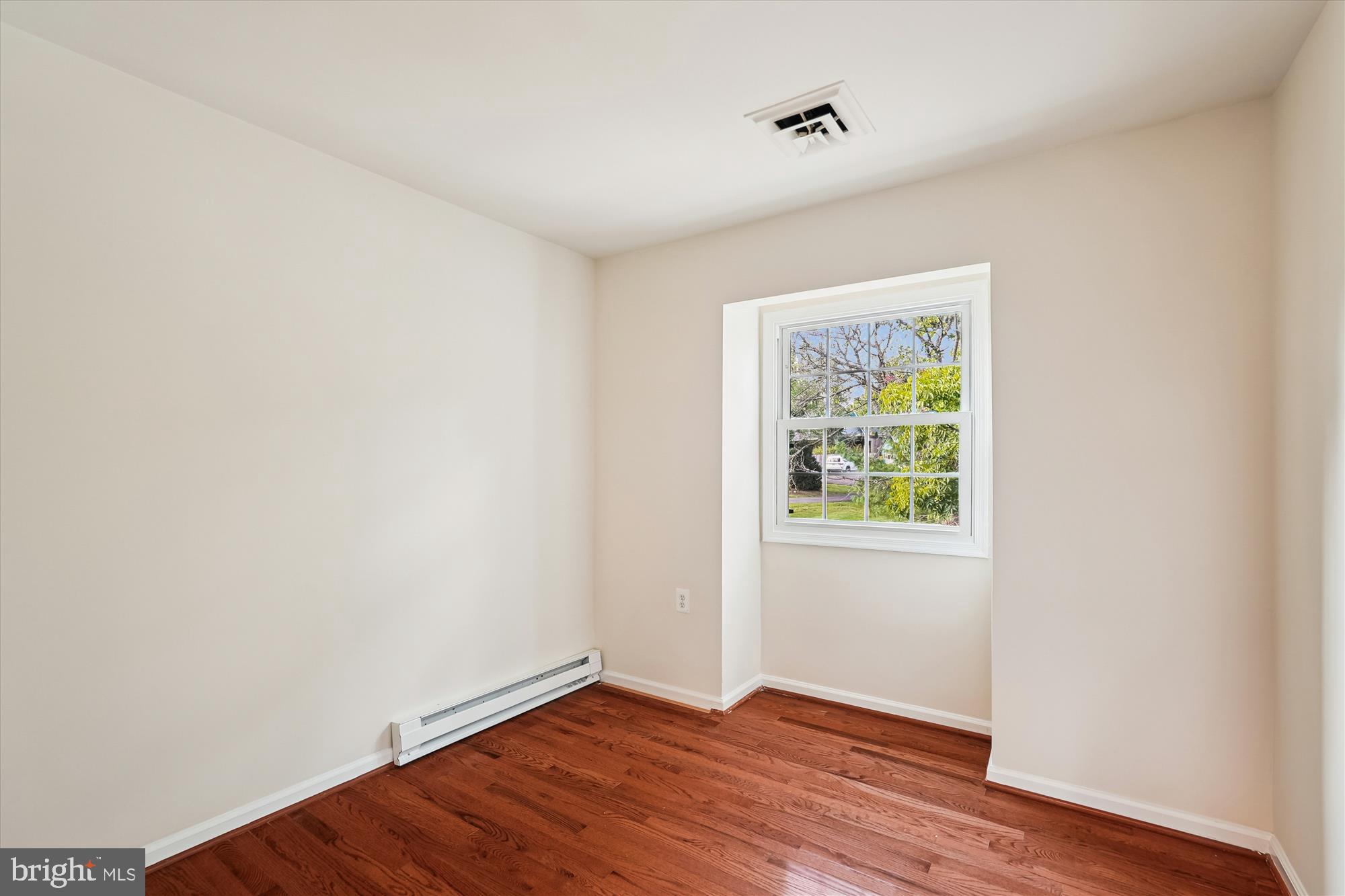 227 Dry Mill Road Southwest Leesburg, VA 20175 - Photo 22 of 38 an empty room with wooden floor and windows
