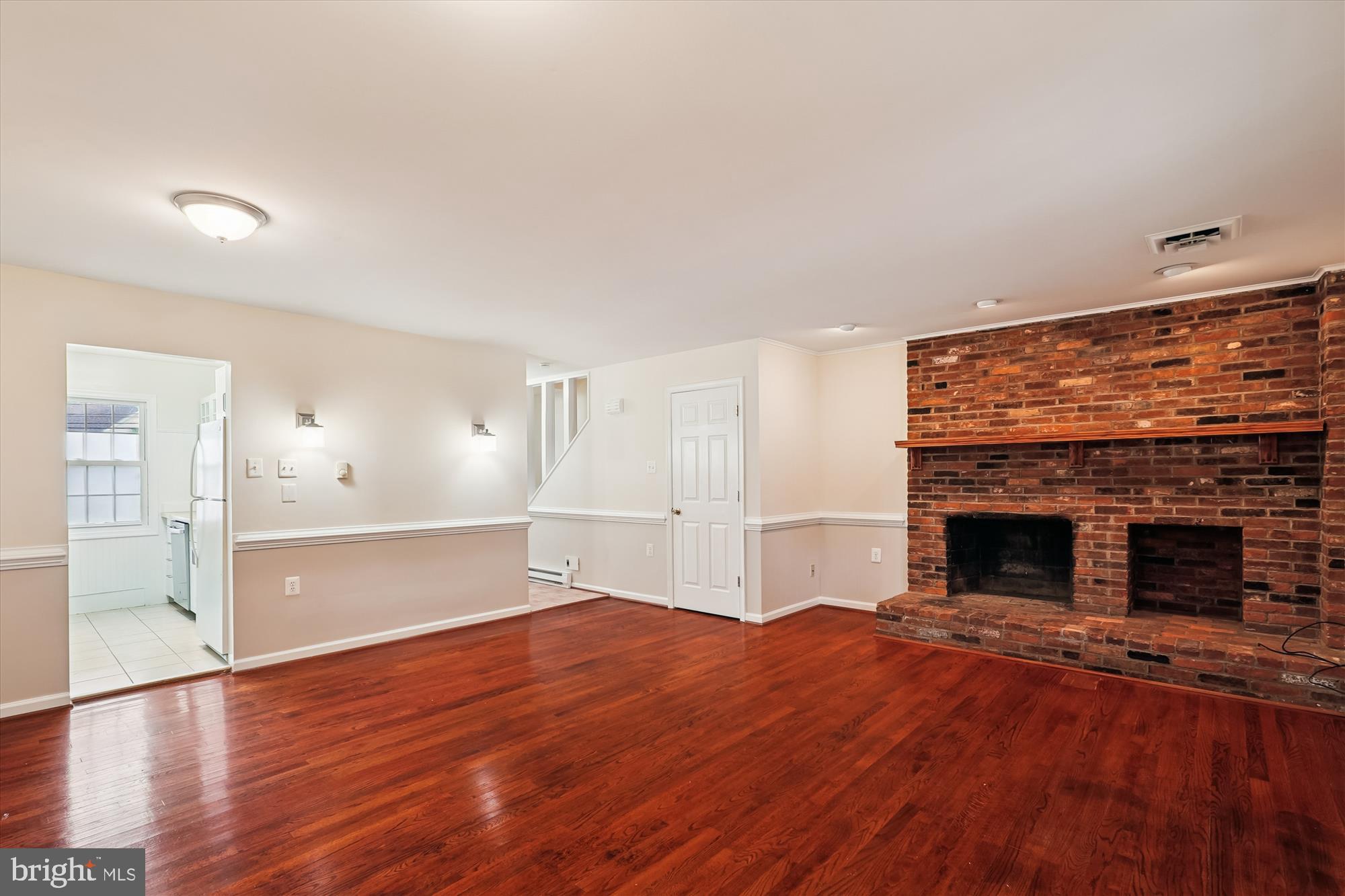 227 Dry Mill Road Southwest Leesburg, VA 20175 - Photo 8 of 38 a view of empty room with wooden floor and fireplace