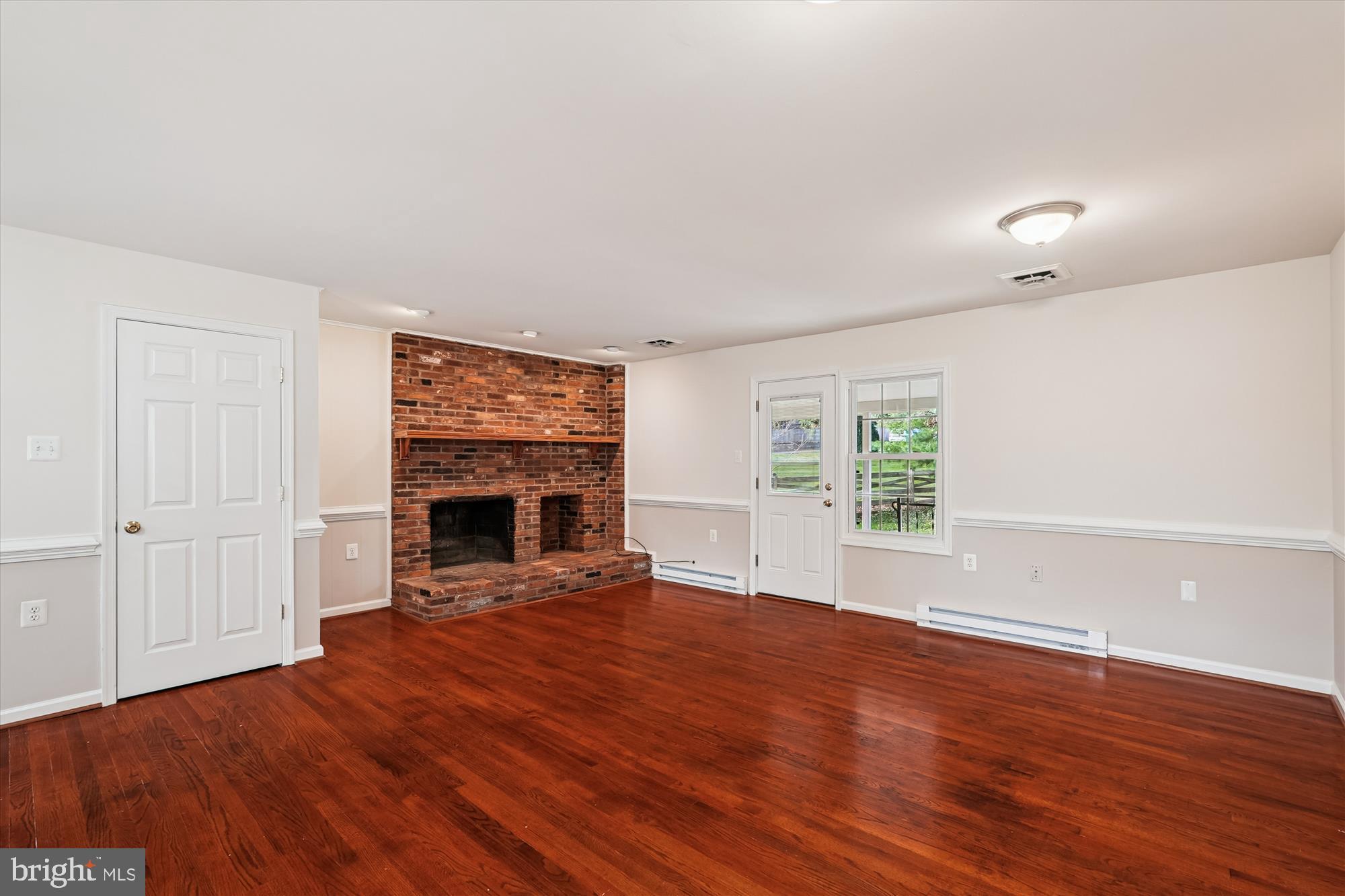 227 Dry Mill Road Southwest Leesburg, VA 20175 - Photo 9 of 38 wooden floor fireplace and natural light in room