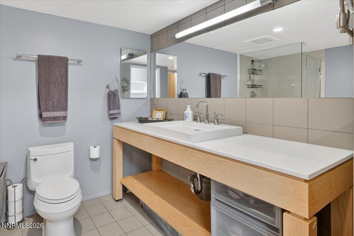 255 North Sierra Street, Unit S 1919 Reno, NV 89501 - Photo 19 of 42 a bathroom with a sink toilet and mirror
