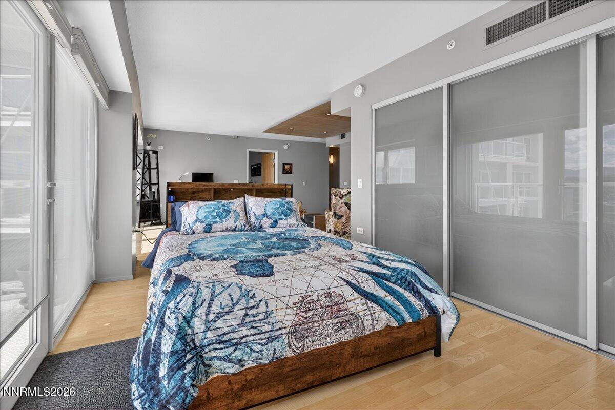 255 North Sierra Street, Unit S 1919 Reno, NV 89501 - Photo 24 of 42 a bedroom with a bed and wooden floor