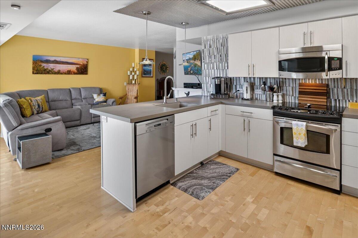 255 North Sierra Street, Unit S 1919 Reno, NV 89501 - Photo 5 of 42 a kitchen with stainless steel appliances granite countertop a stove and a sink