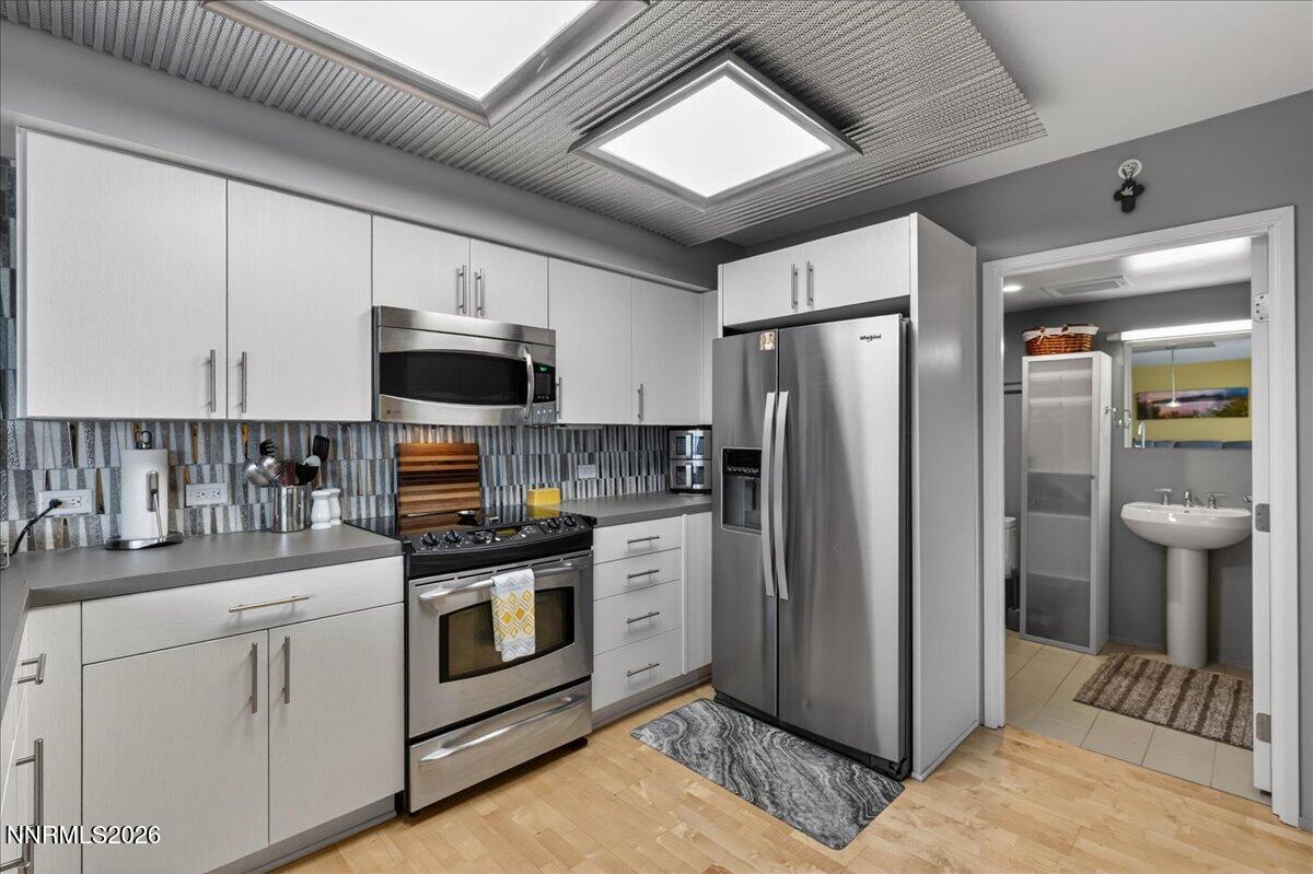 255 North Sierra Street, Unit S 1919 Reno, NV 89501 - Photo 10 of 42 a kitchen with stainless steel appliances a refrigerator stove and sink