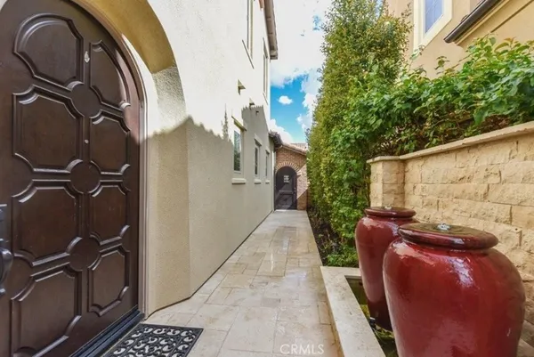 a backyard of a house with fountain table and chairs