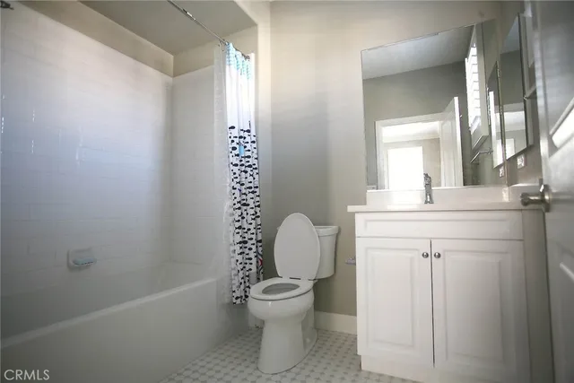 an empty room with wooden floor and window