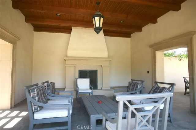 a view of a patio with a dining table and chairs with wooden floor