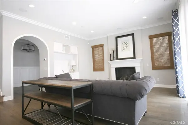 a living room with furniture a fireplace and a large window