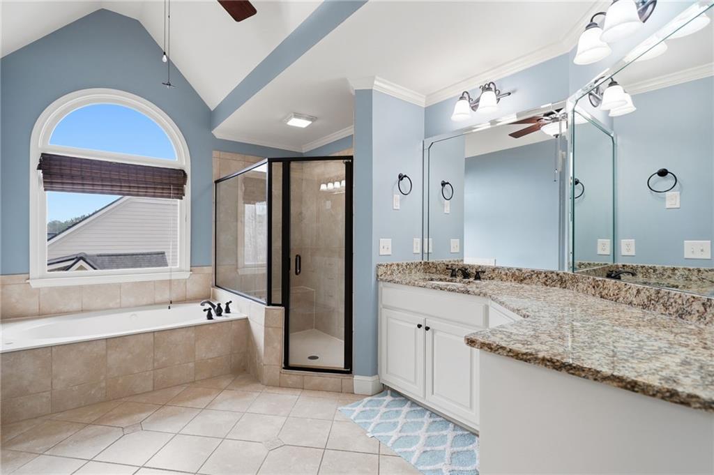507 Blue Ridge Way Canton, GA 30114 - Photo 16 of 33 a spacious bathroom with a granite countertop tub a double vanity sink a vanity and a large mirror