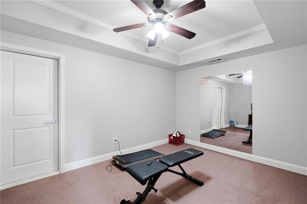 507 Blue Ridge Way Canton, GA 30114 - Photo 23 of 33 a room with gym equipment and a chandelier fan