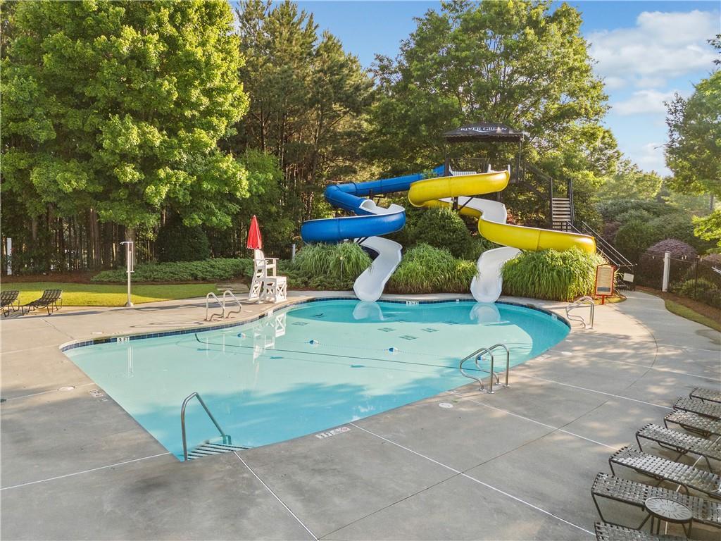 507 Blue Ridge Way Canton, GA 30114 - Photo 31 of 33 a view of a swimming pool with a lawn chairs and a fire pit