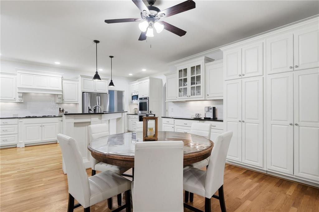 507 Blue Ridge Way Canton, GA 30114 - Photo 5 of 33 a kitchen with stainless steel appliances kitchen island granite countertop a table chairs and a refrigerator