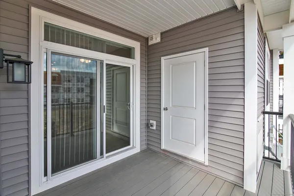 a view of a porch with wooden floor and a window