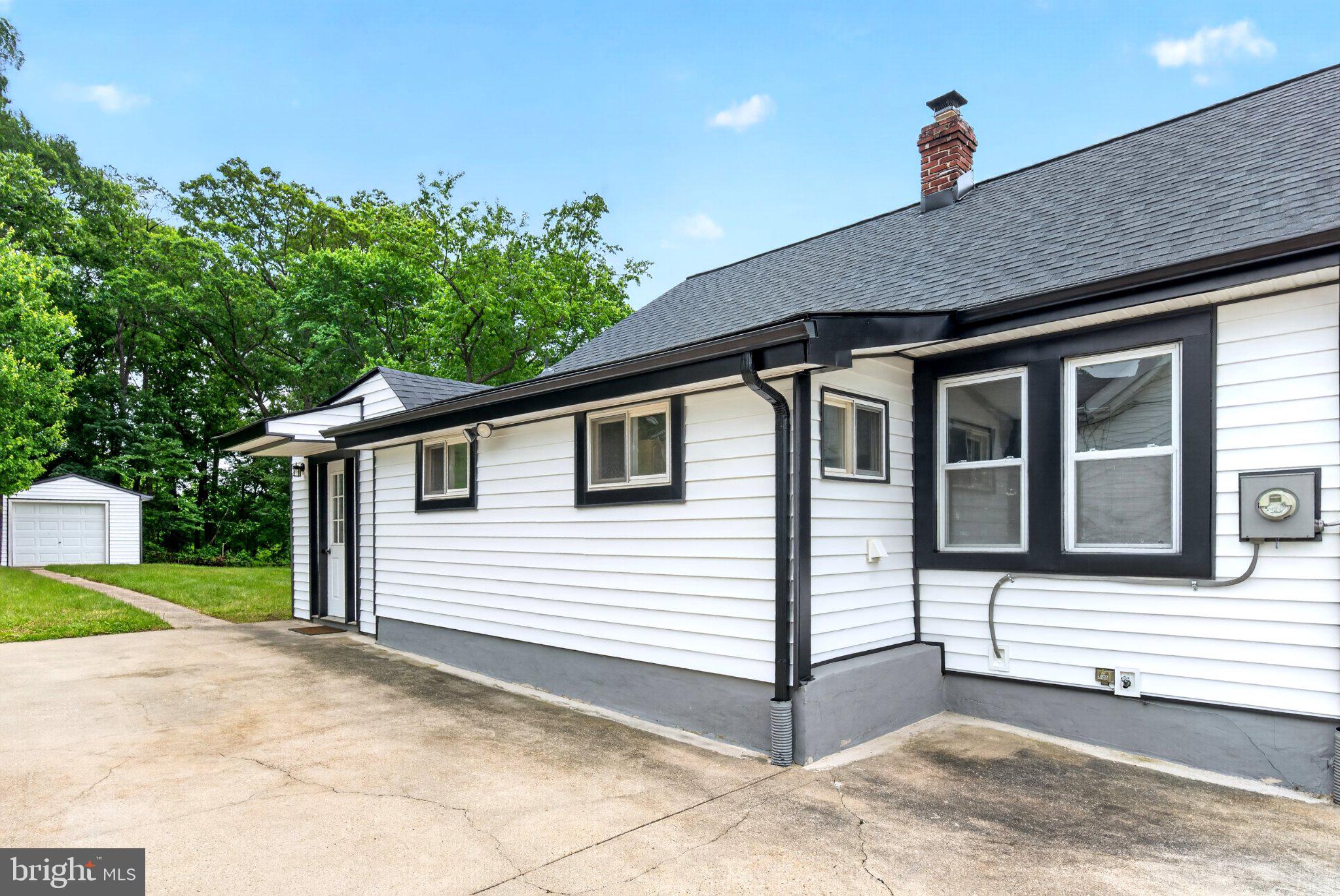 9081 Dumhart Road Laurel, MD 20723 - Photo 5 of 45 Charming home with lush greenery backdrop.