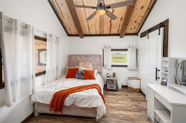 a bedroom with a bed next to a window