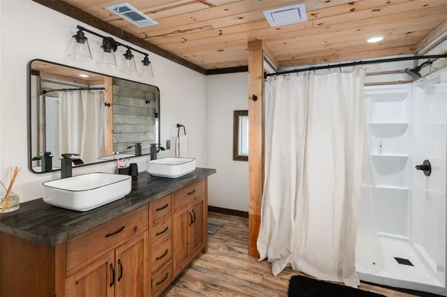 a bathroom with a double vanity sink and a mirror