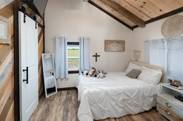 a bedroom with bed and a window