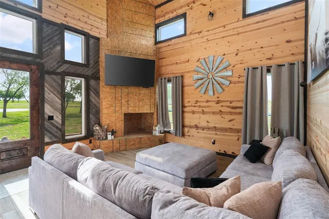 a view of a patio with couches chairs and a fireplace